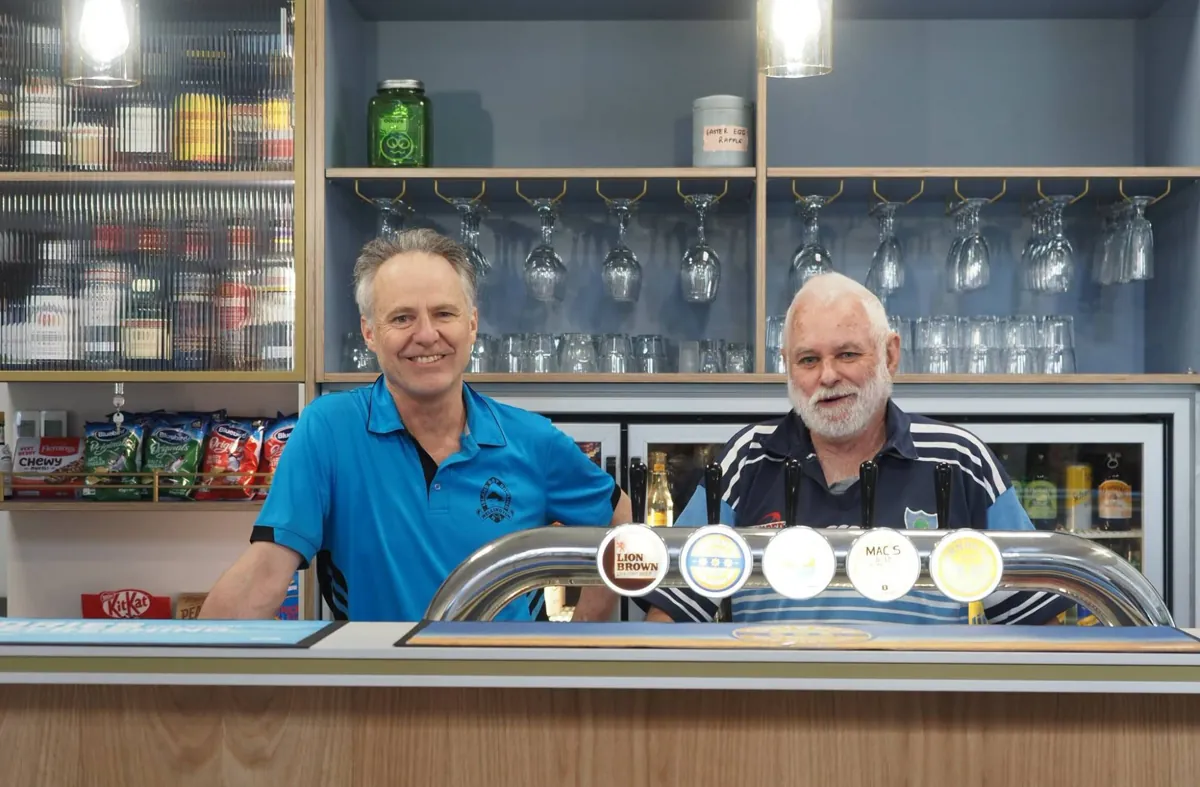 Two club members at the new bar with beer taps