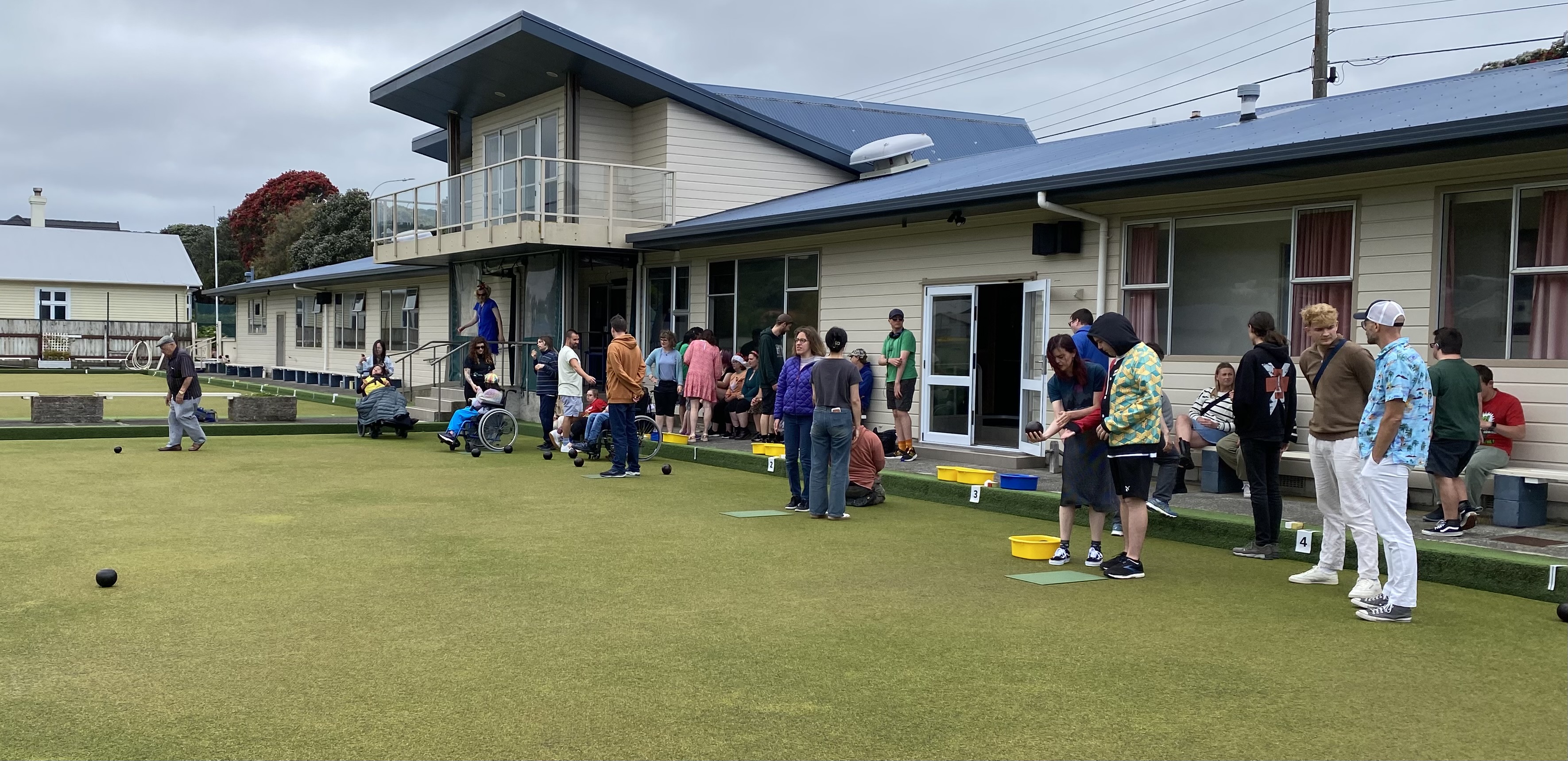 New member learning to bowl with instructor